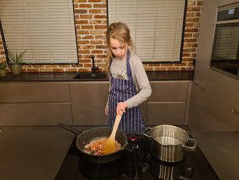 Full length of woman having food at home