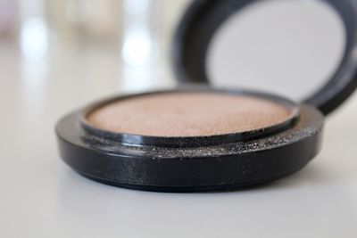 Close-up of powder compact on table