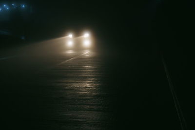 View of illuminated street lights at night