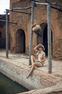 A traveler woman  is sitting in an old eastern city in the summer