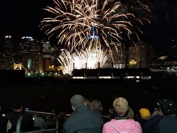 Firework display in city at night