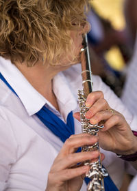 Close-up of woman playing musical instrument