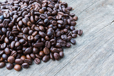 Close-up of roasted coffee beans on table