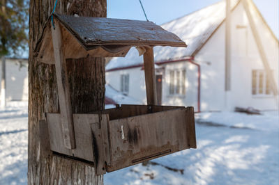 Low angle view of wooden post against sky