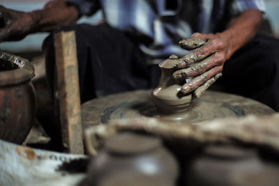 Midsection of man working at workshop