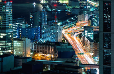 Aerial view of illuminated city buildings at night