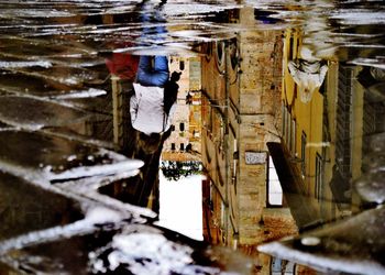 Reflection of building in puddle