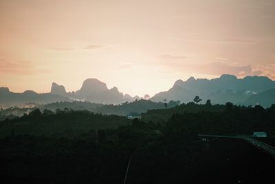 Scenic view of silhouette mountains against sky at sunset