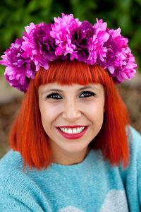 Portrait of smiling woman wearing wreath outdoors