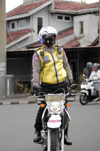 Man riding bicycle on street in city