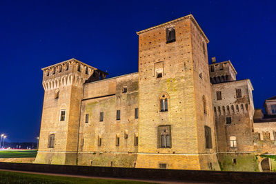 Low angle view of historic building against blue sky