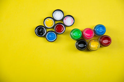 High angle view of multi colored pencils on yellow background