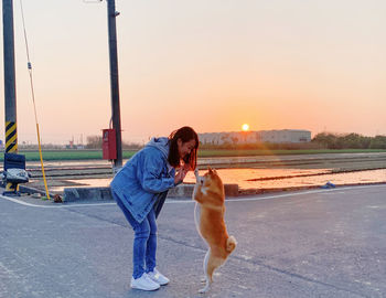 Side view of man with dog on road