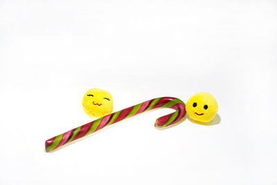 Close-up of yellow toys against white background