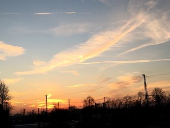 Low angle view of silhouette trees against sky at sunset