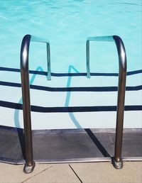 High angle view of chairs in swimming pool