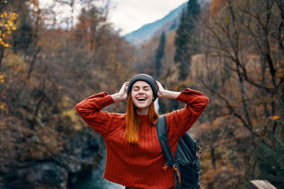 Young woman standing in park during autumn