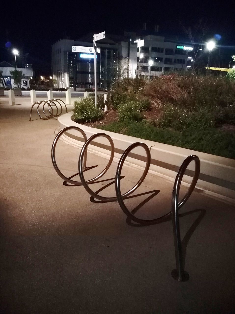 BICYCLE PARKED ON STREET AGAINST BUILDINGS