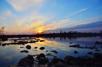 Scenic view of lake against sky during sunset