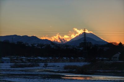 Snow covered landscape at sunset