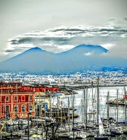 Boats in harbor with cityscape in background