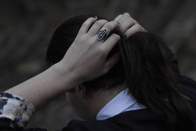 Close-up of woman tying hair