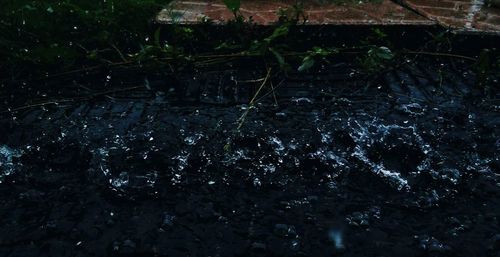 High angle view of raindrops on rocks