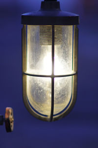 Close-up of illuminated lamp against sky