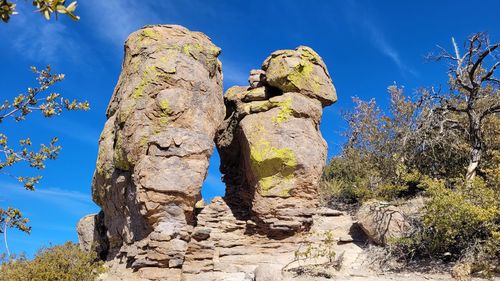 Low angle view of rock formation against sky