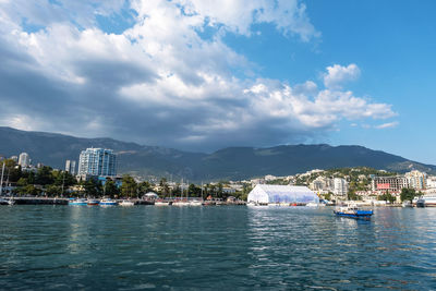 Scenic view of sea by city against sky