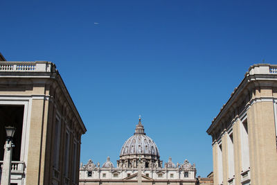 Low angle view of buildings against clear blue sky