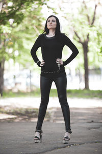 Full length of young woman exercising in park