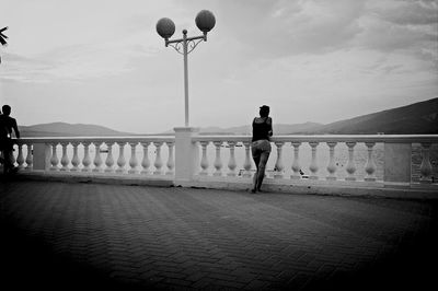 Silhouette of woman standing against sky