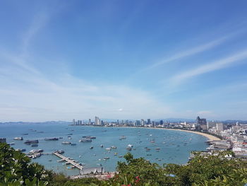 High angle view of city by sea against sky