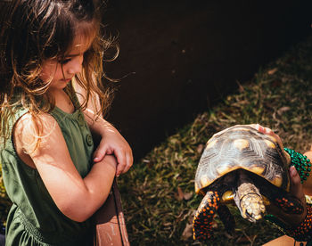 Rear view of girl with arms raised