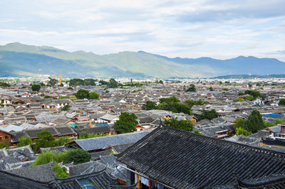 Houses in town against mountains and sky