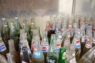 Close-up of various bottles on glass