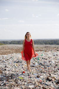 Portrait of young woman standing on land