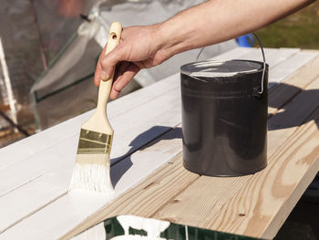 Close-up of hand holding ice cream on table