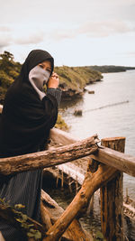 Woman on beach against sky