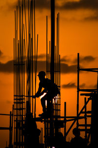 Silhouette of construction worker at sunset