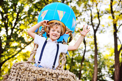 Portrait of smiling boy standing in hot air balloon