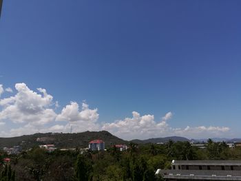 Scenic view of mountains against blue sky