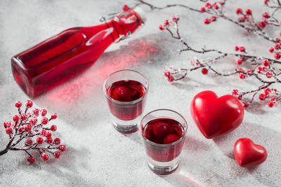 Red cocktail, vodka or liqueur and heart shape decorations