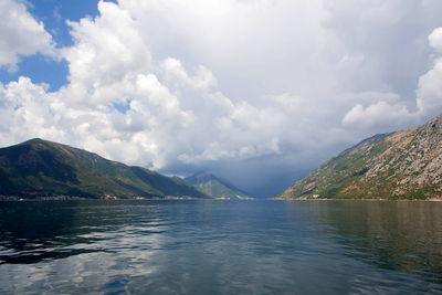 Scenic view of lake and mountains against sky