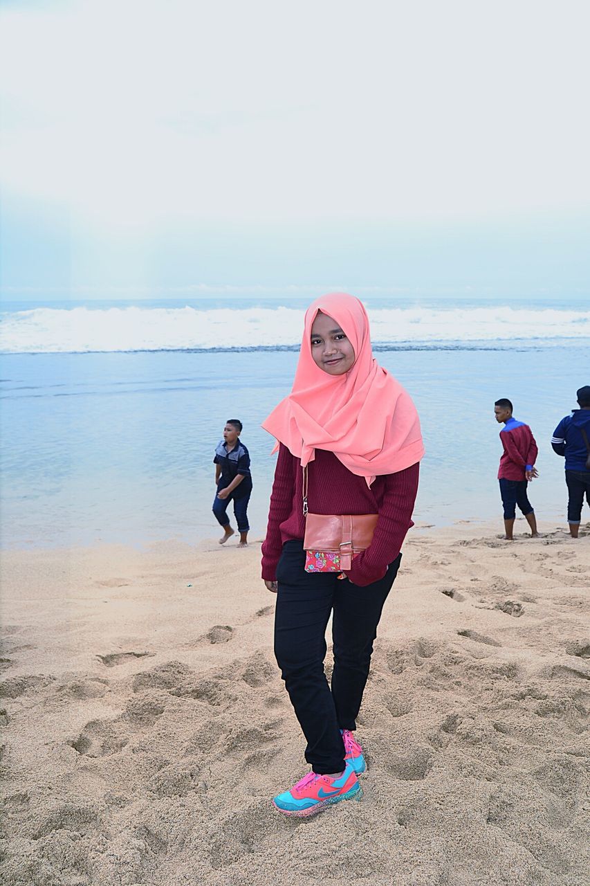 REAR VIEW OF WOMEN ON BEACH