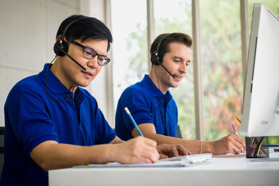 Male agents working at desk in office