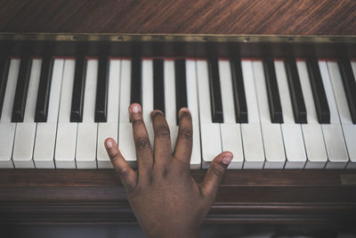 Cropped hand playing piano