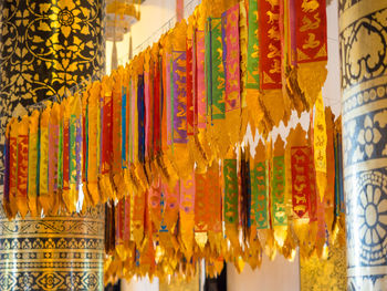 Multi colored flags hanging at market stall