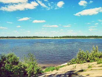 Scenic view of lake against cloudy sky